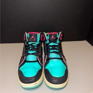 Neon hot pink, blue and black Nike Jordan’s